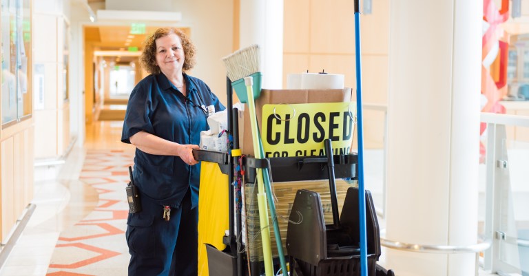 Custodian with work cart.