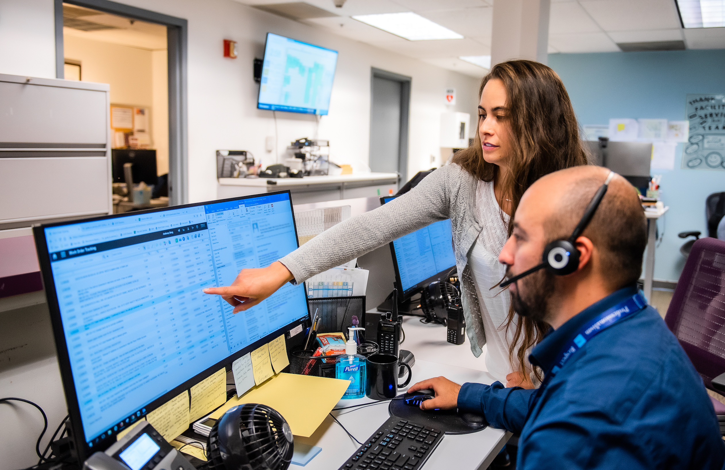 Customer Service Center team looking at data on a computer screen.
