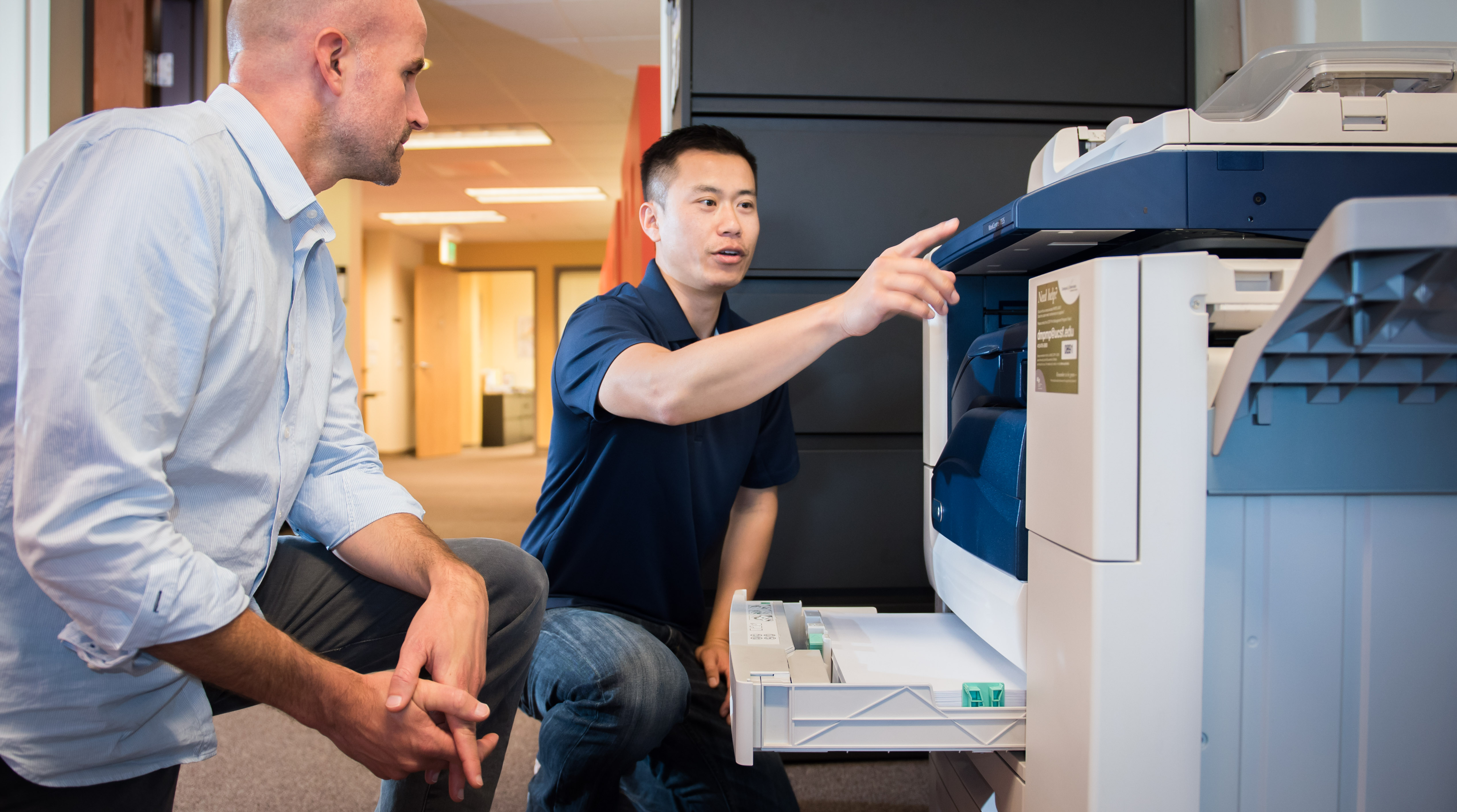 DM Print Management team instructing client on machine operation