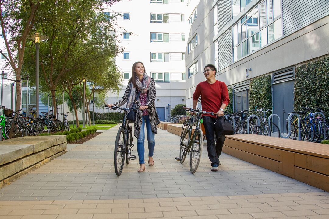 Students walking bikes