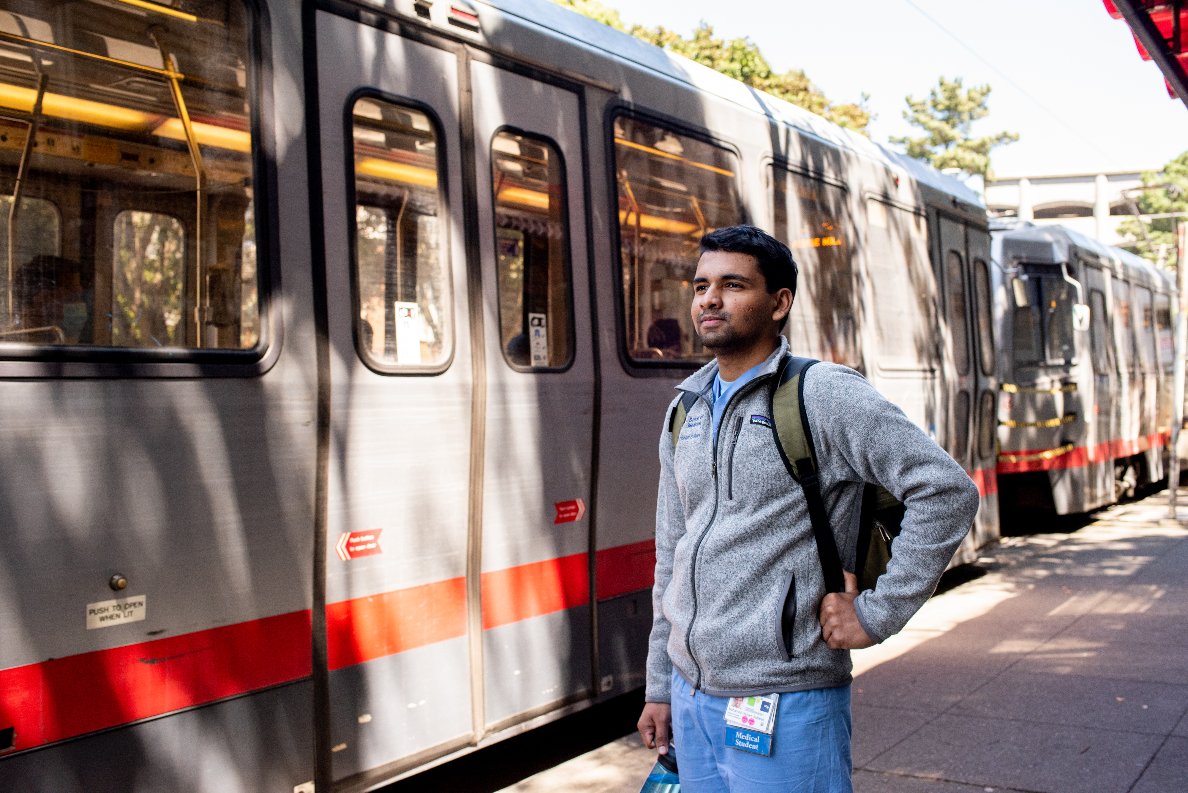 UCSF Student next to a MUNI train