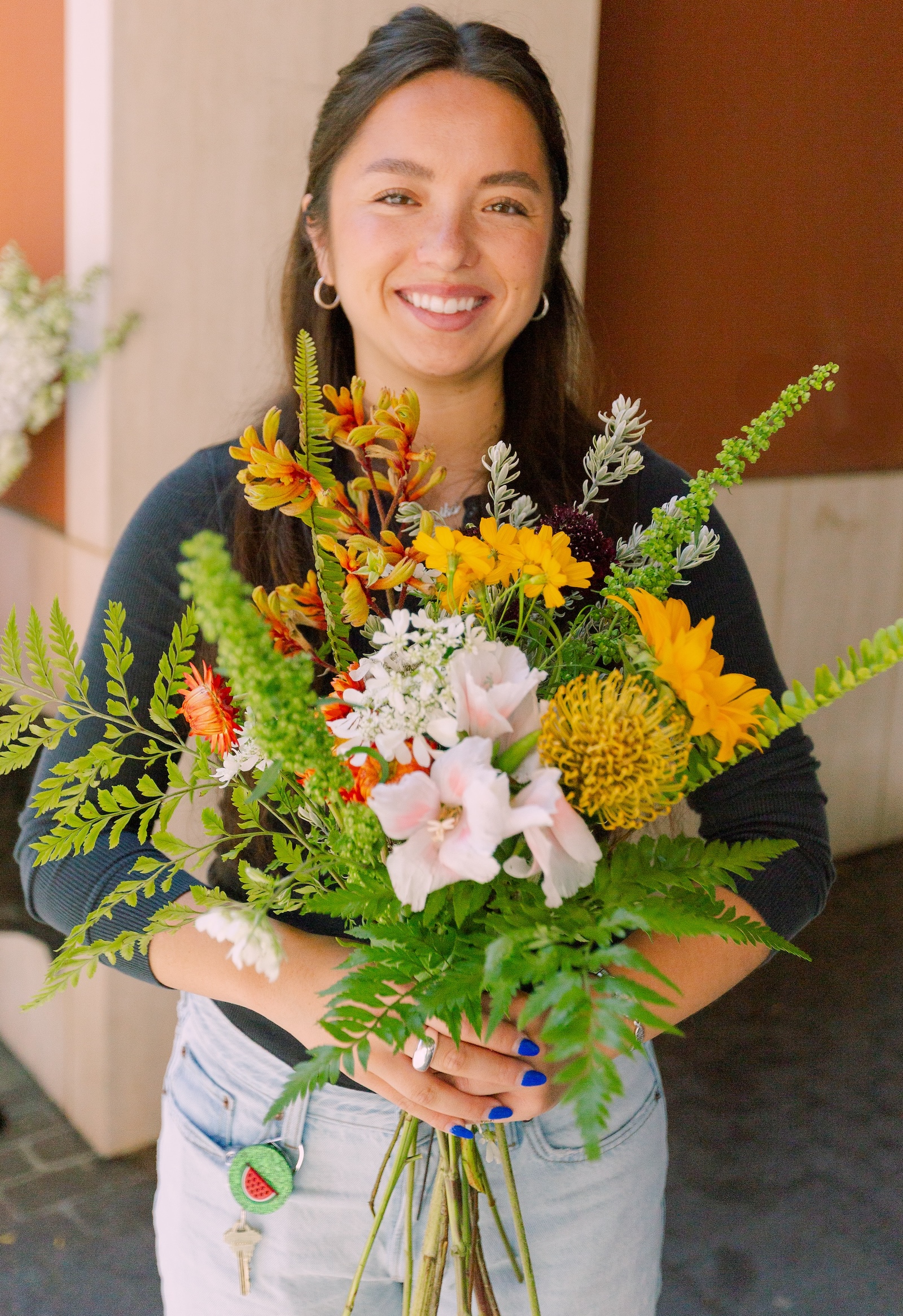 Woman holding flowers and smiling 
