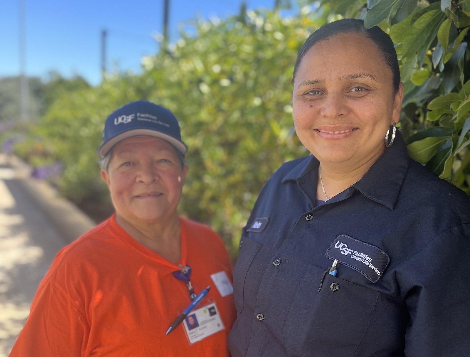 Custodian Marlen Amado and Senior Custodian Maria Acosta pose at the Turnover Party
