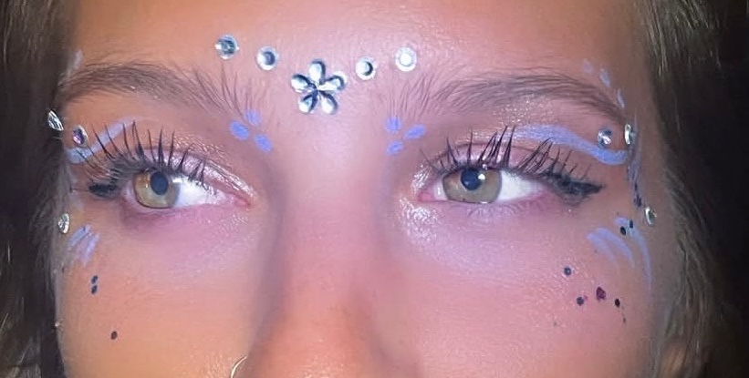woman with face gems around her eyes