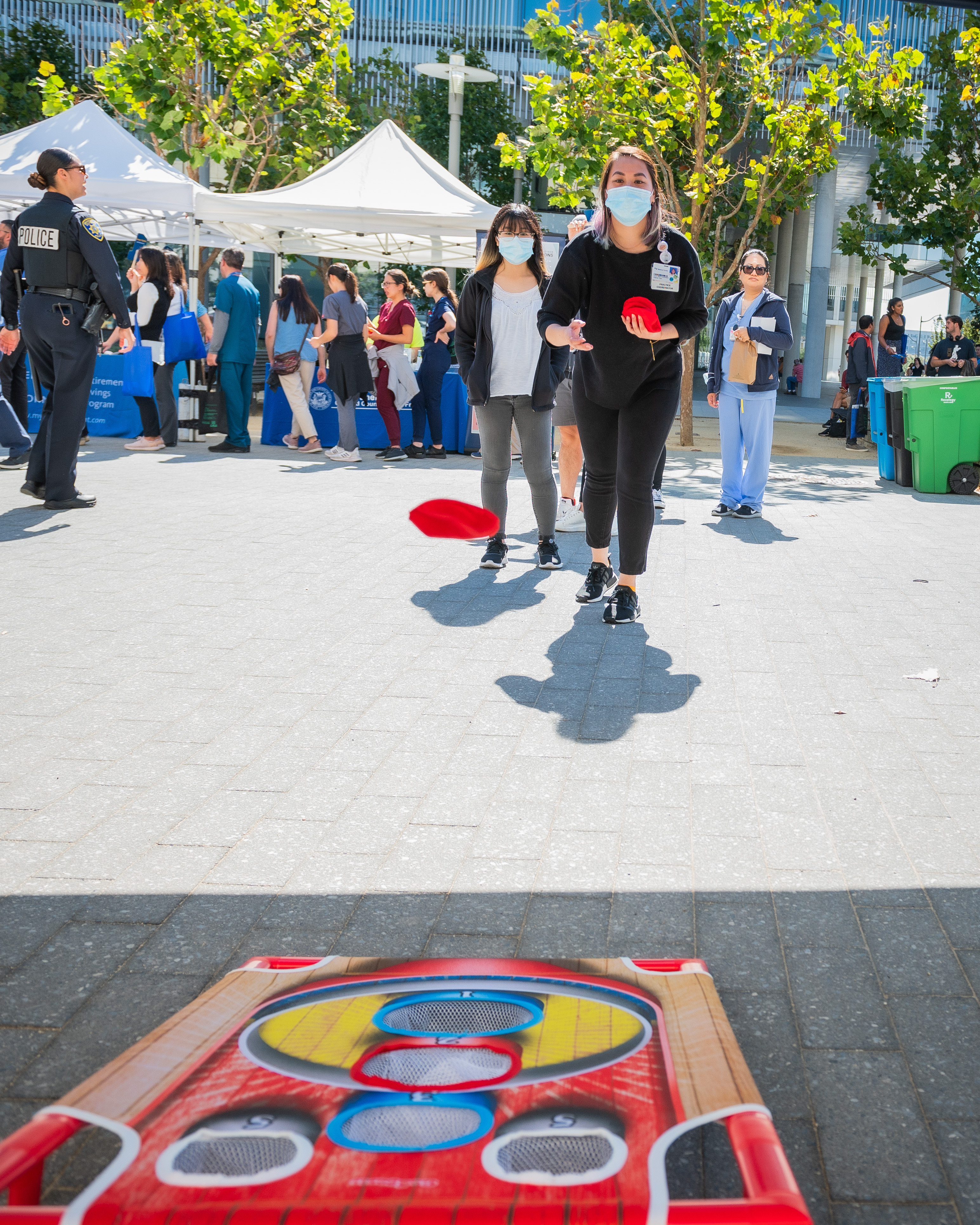Person throwing a corn hole bag