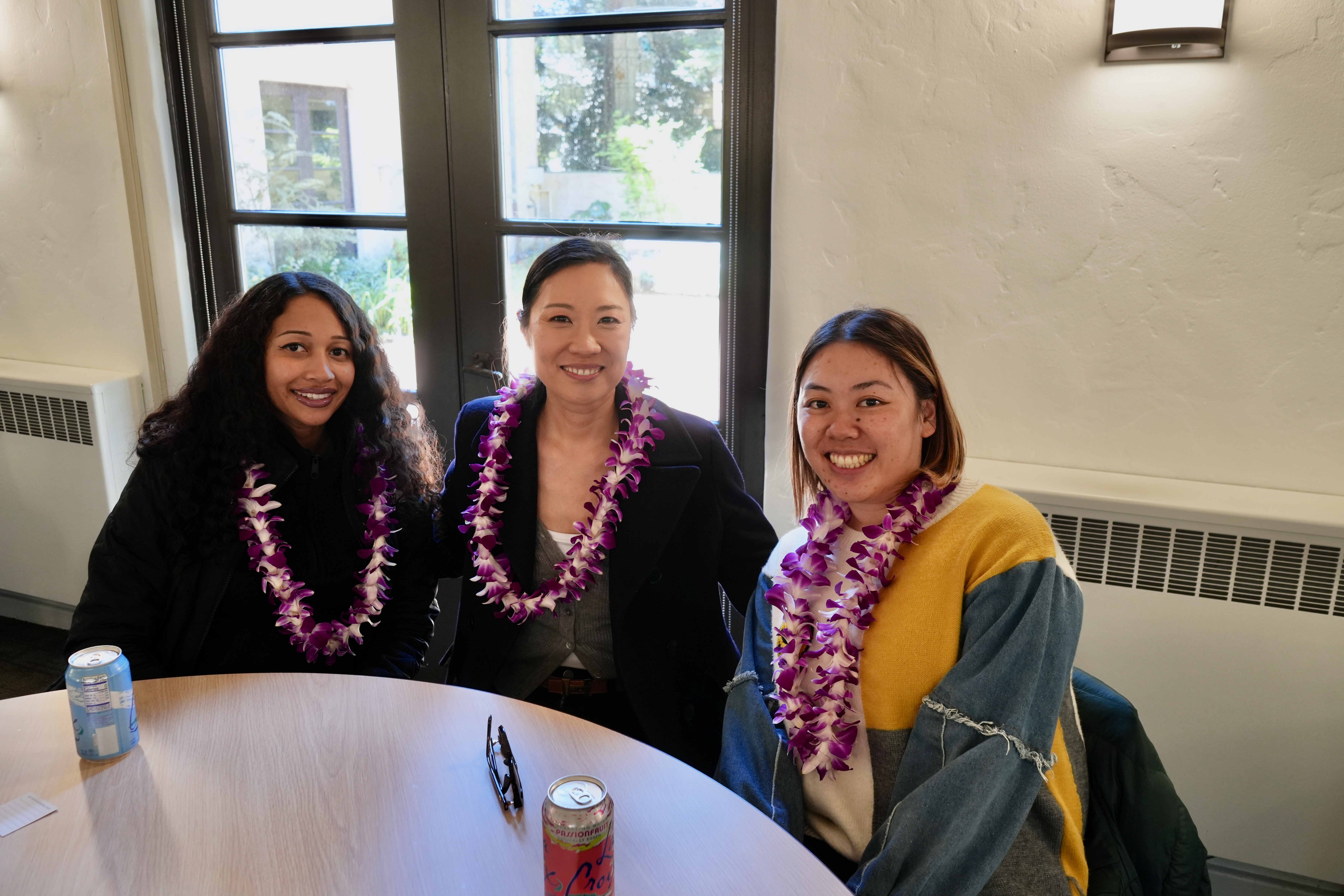 Three staff share a smile at the event.