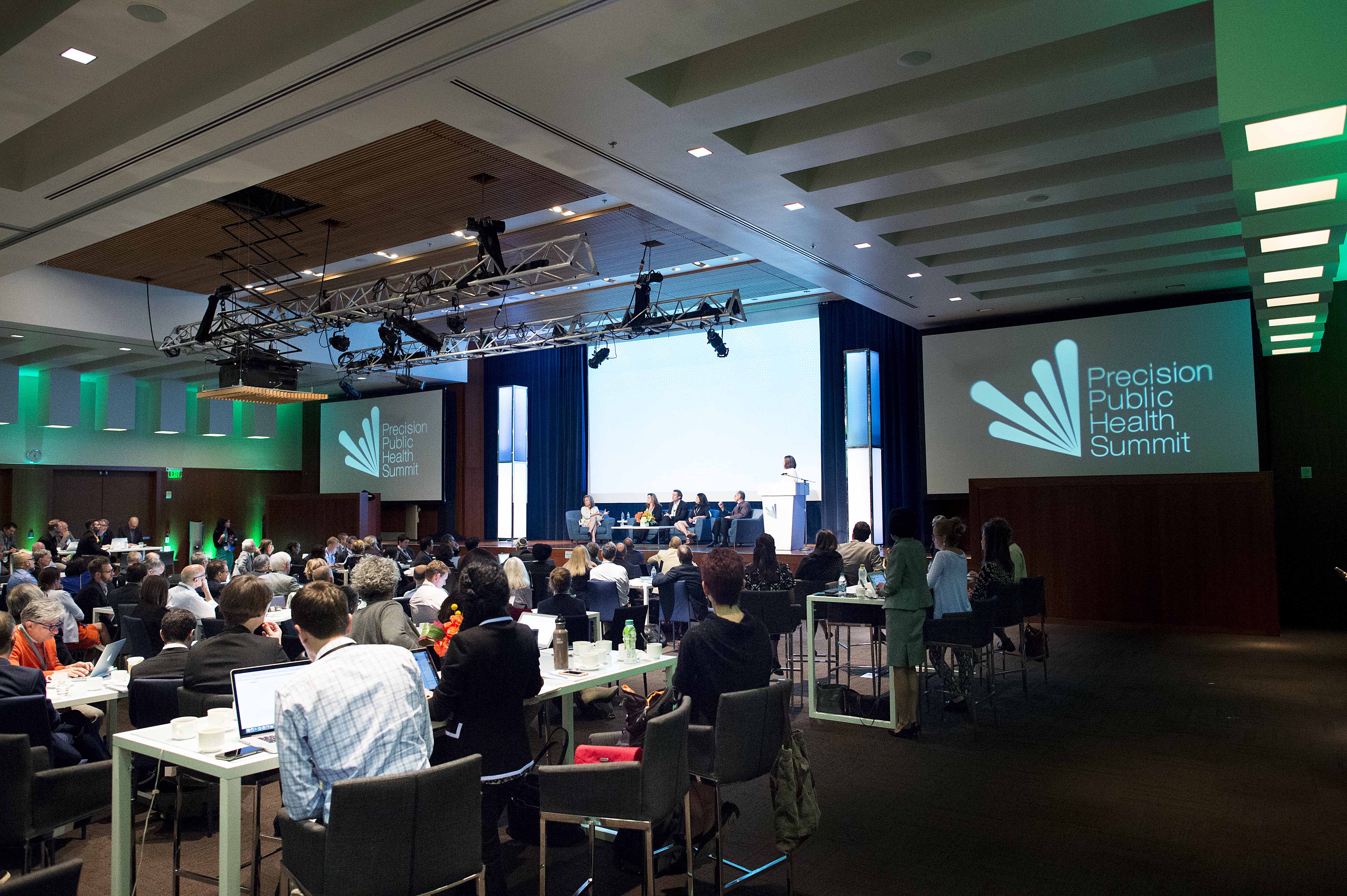 Conference audience watching a panel on stage