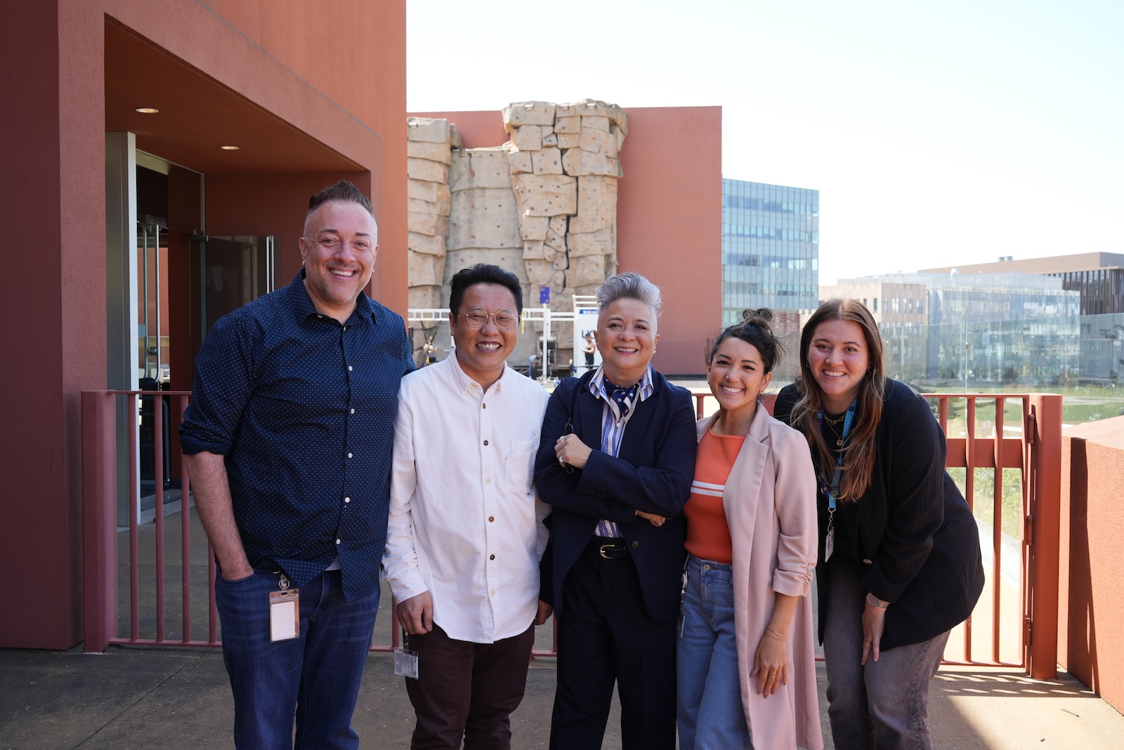 Monica poses with team members on the balcony of Rutter Center
