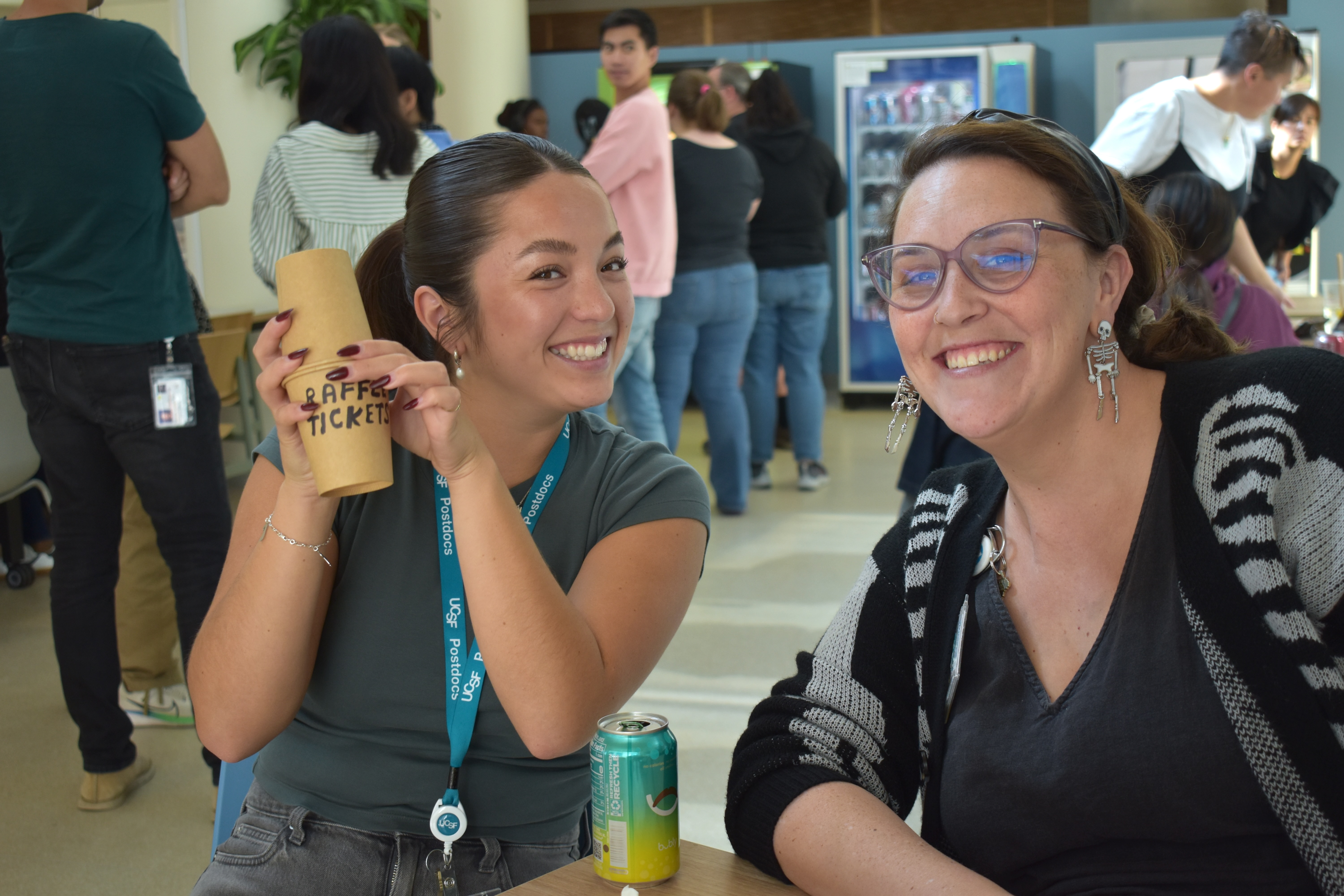 Events Assistants Annika Le and Amy Fazio pose while shuffling tickets for drawing