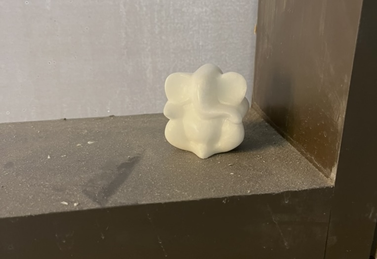 Small ivory charm of Ganesh sits in the corner.