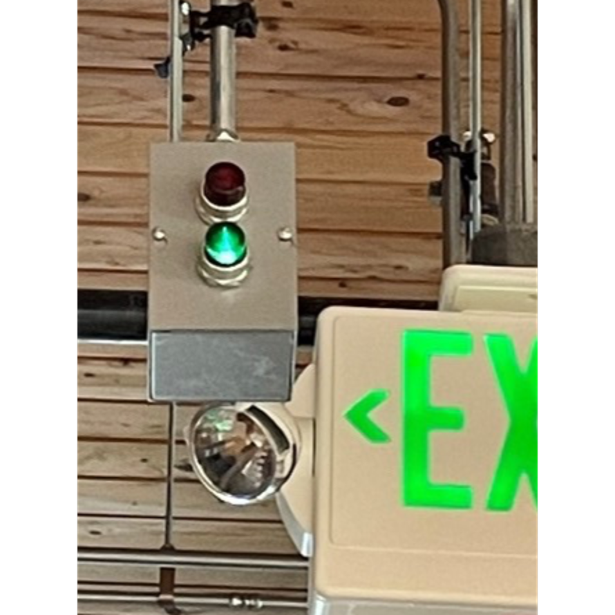 green indicator light next to the exit sign