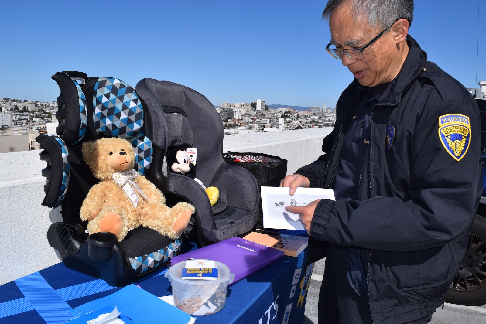 Child Passenger Safety Technician Frank Yee points to the safety handout he designed for parents