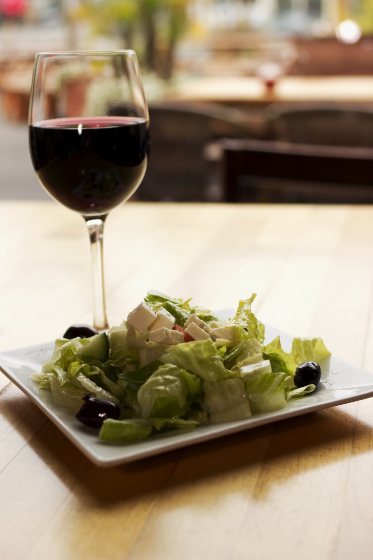 Glass of wine sitting on a table.