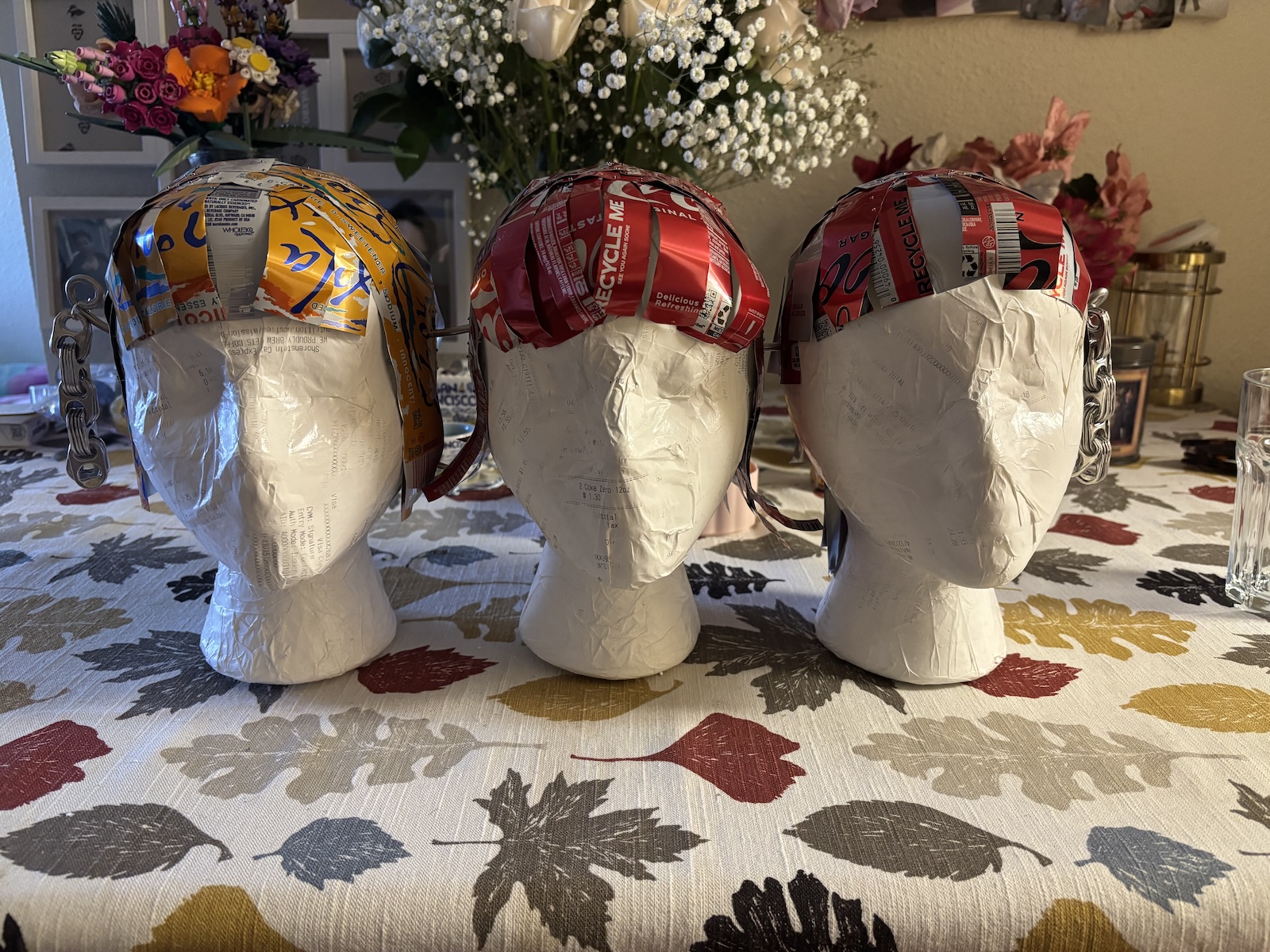 Three heads with cardboard hair.