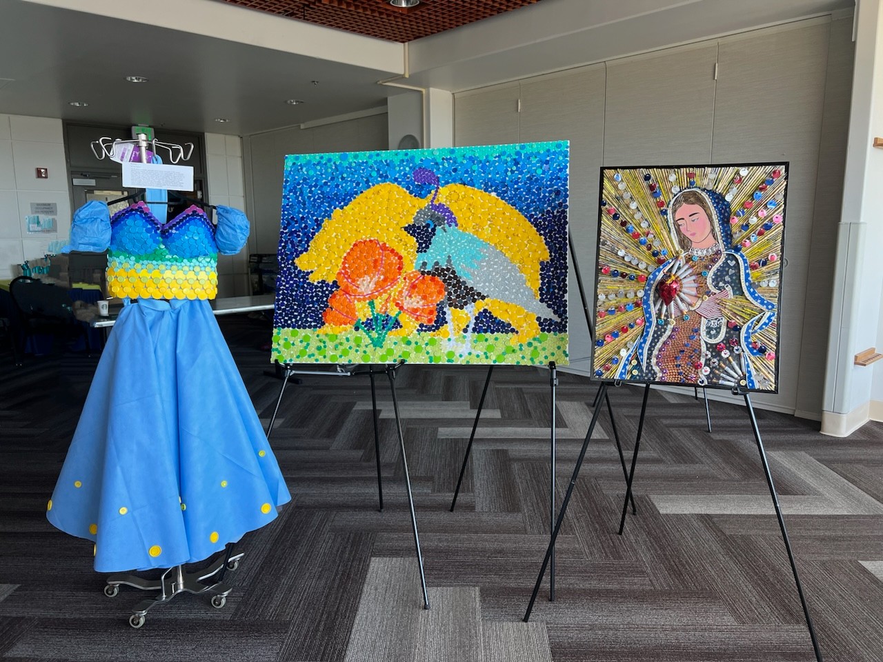 Blue gown with bright beads on the left, mosaic california bear, poppy, and quail in the middle, lady in gown with gold background on the right 