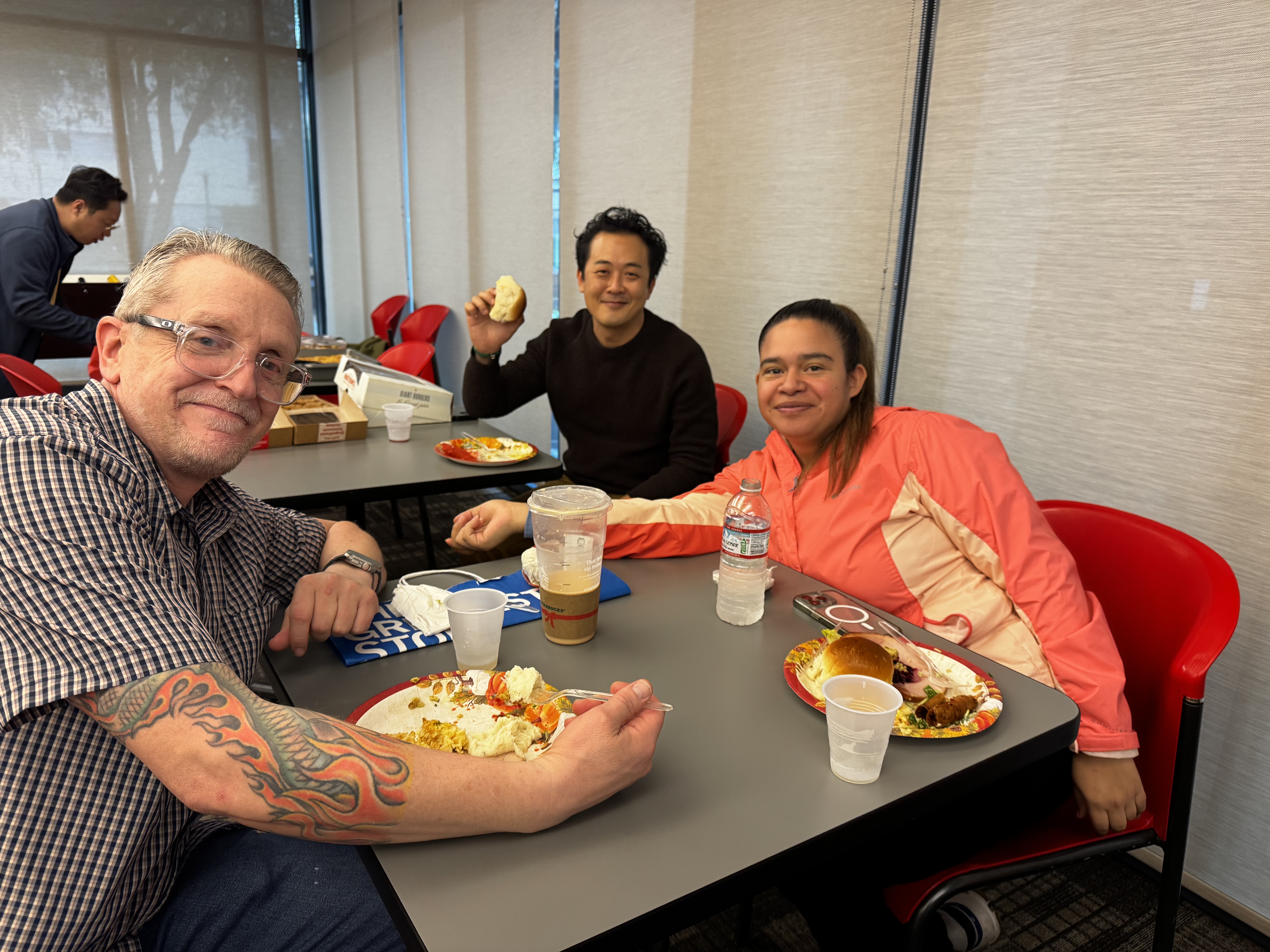 Staff members post with food