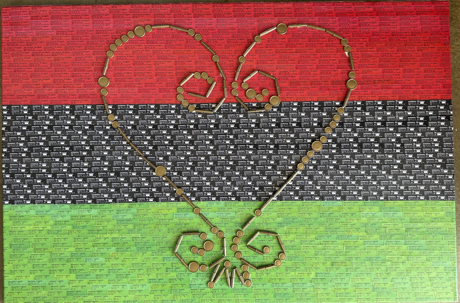 A gold heart-shaped symbol against a green, black and red backdrop