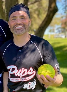 Kyser smiling holding a softball. 