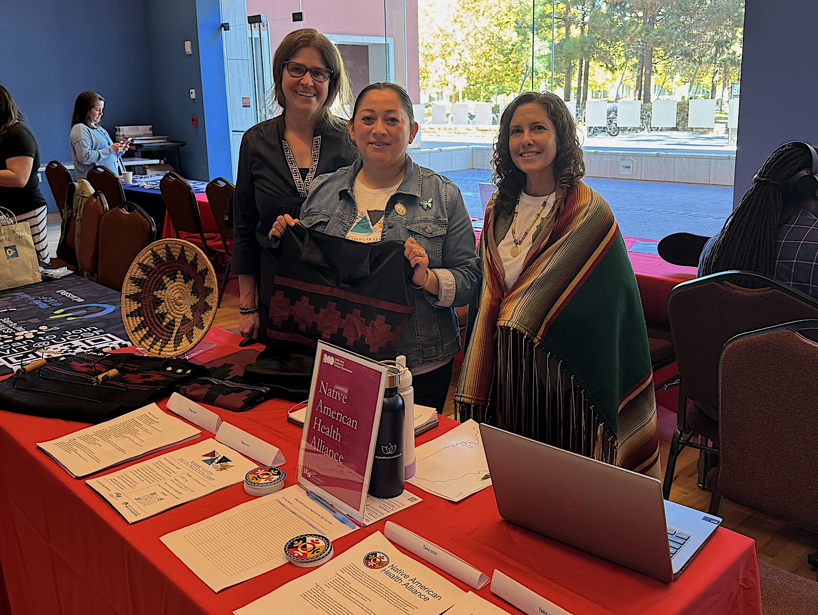 Native American Health Alliance Members host table with information for attendees