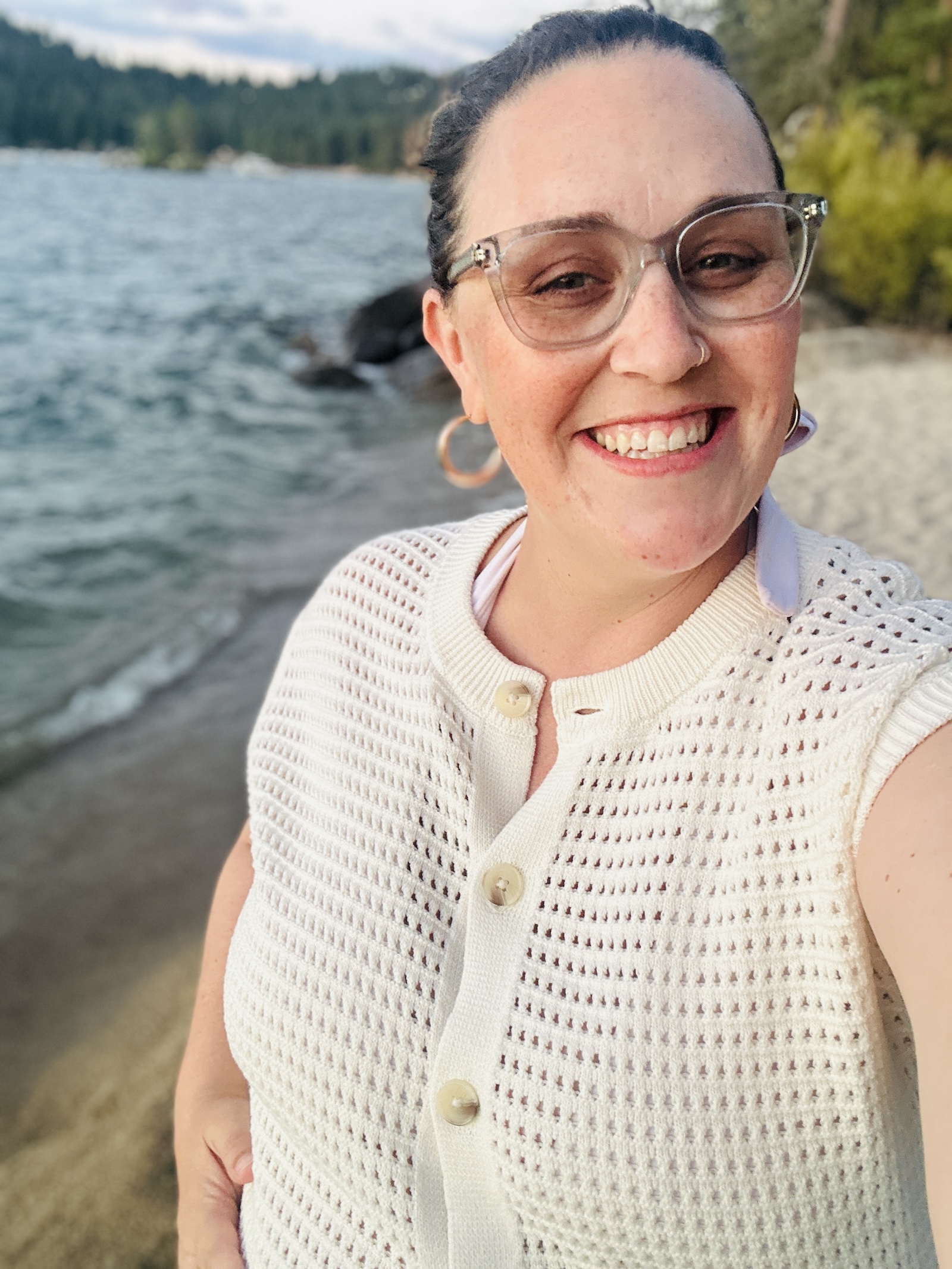 Woman smiling at the camera with beach in the background