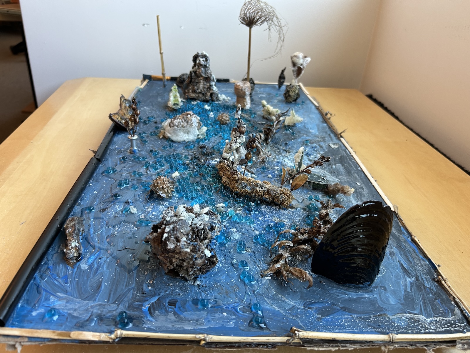 mixed media collage against blue backdrop