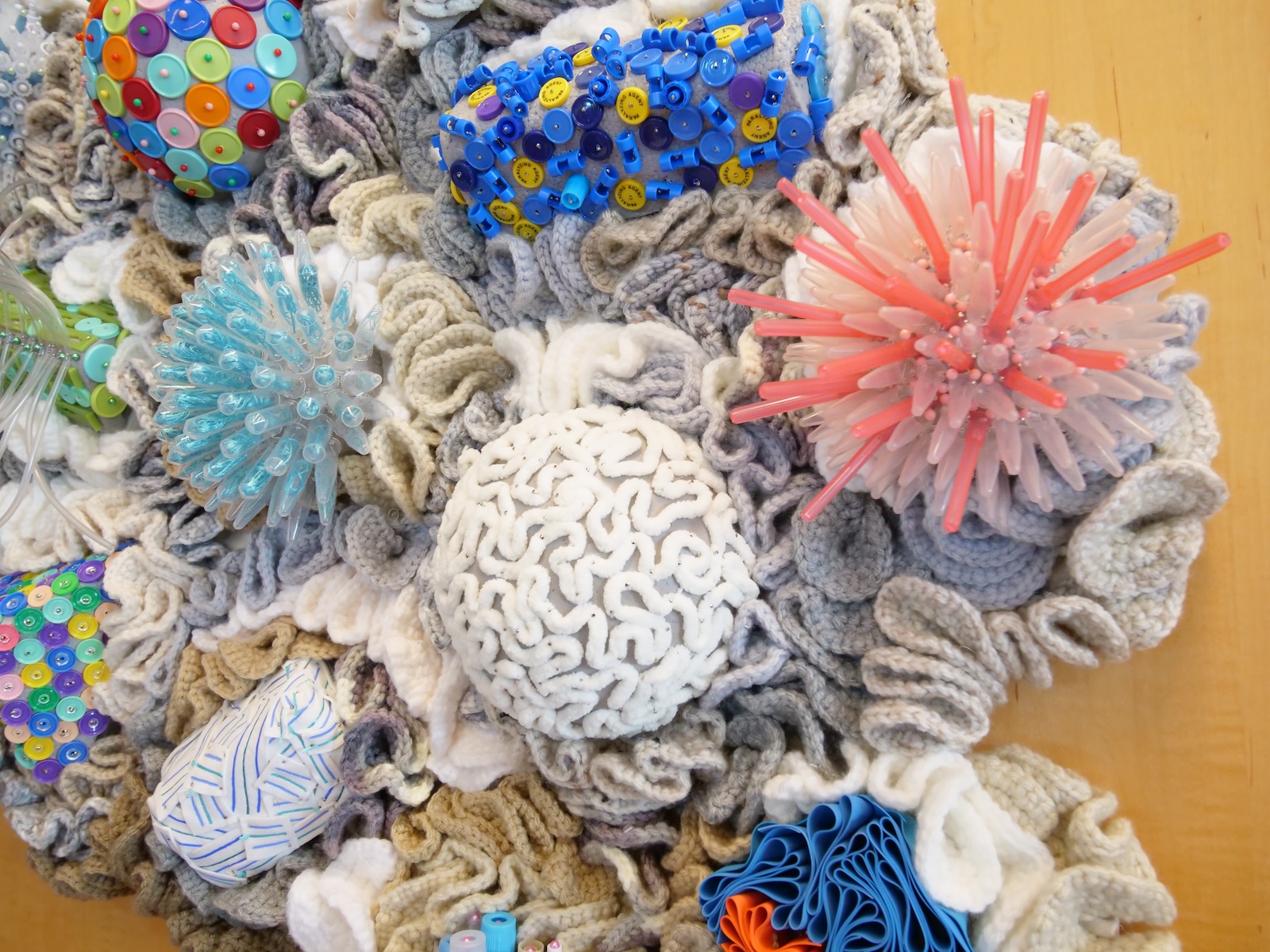 An assemblage of coral reefs made of yarn and pipettes