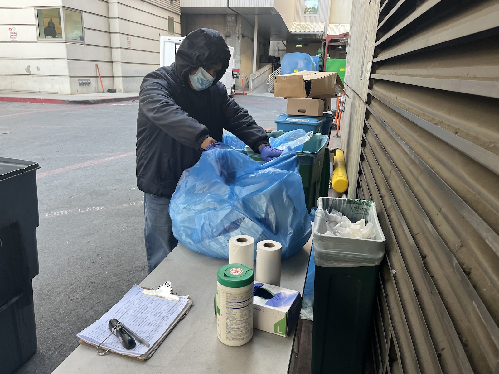 EVS recycling sorter Narcisco Flores inspecting recycling bags to ensure they are sorter correctly.