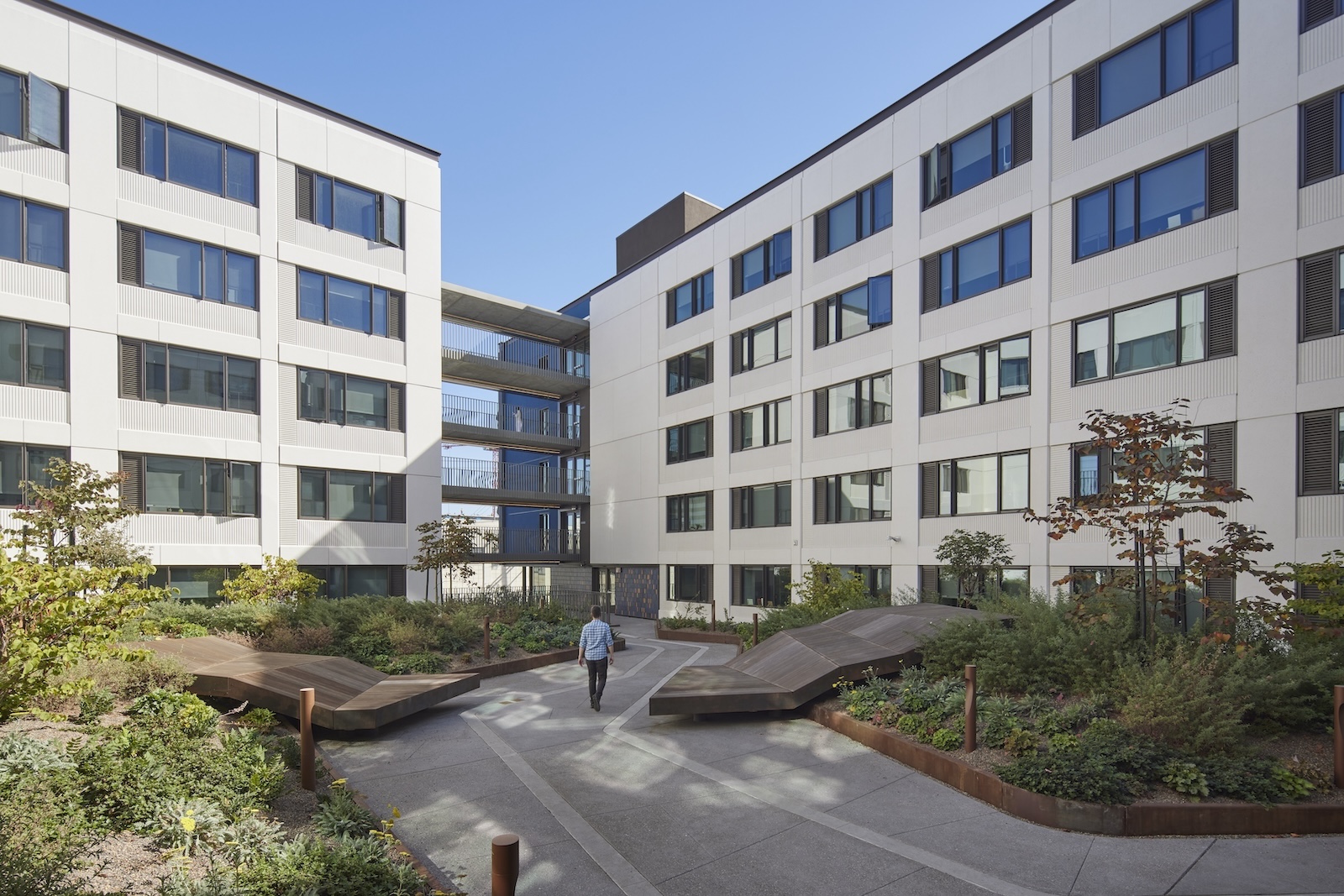 A man walks through the courtyard at The Tidelands. Photo Credit Daniel Cambier