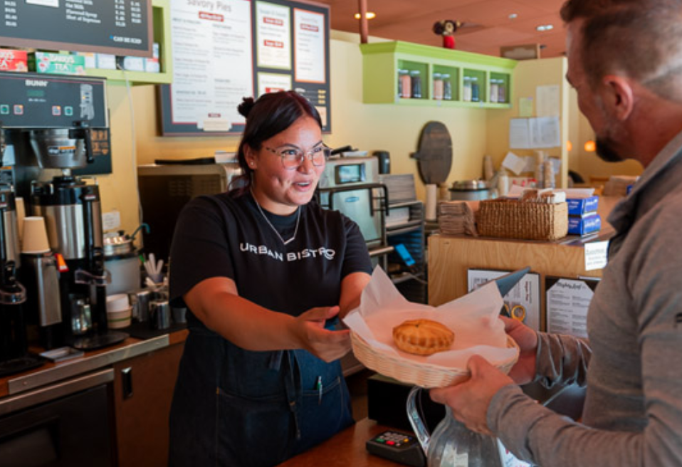 Peasant Pies server handing a pie to a customer