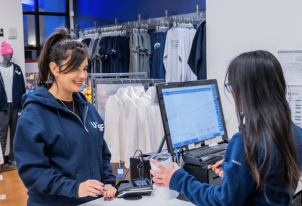 Customer purchasing UCSF cup at the cash register