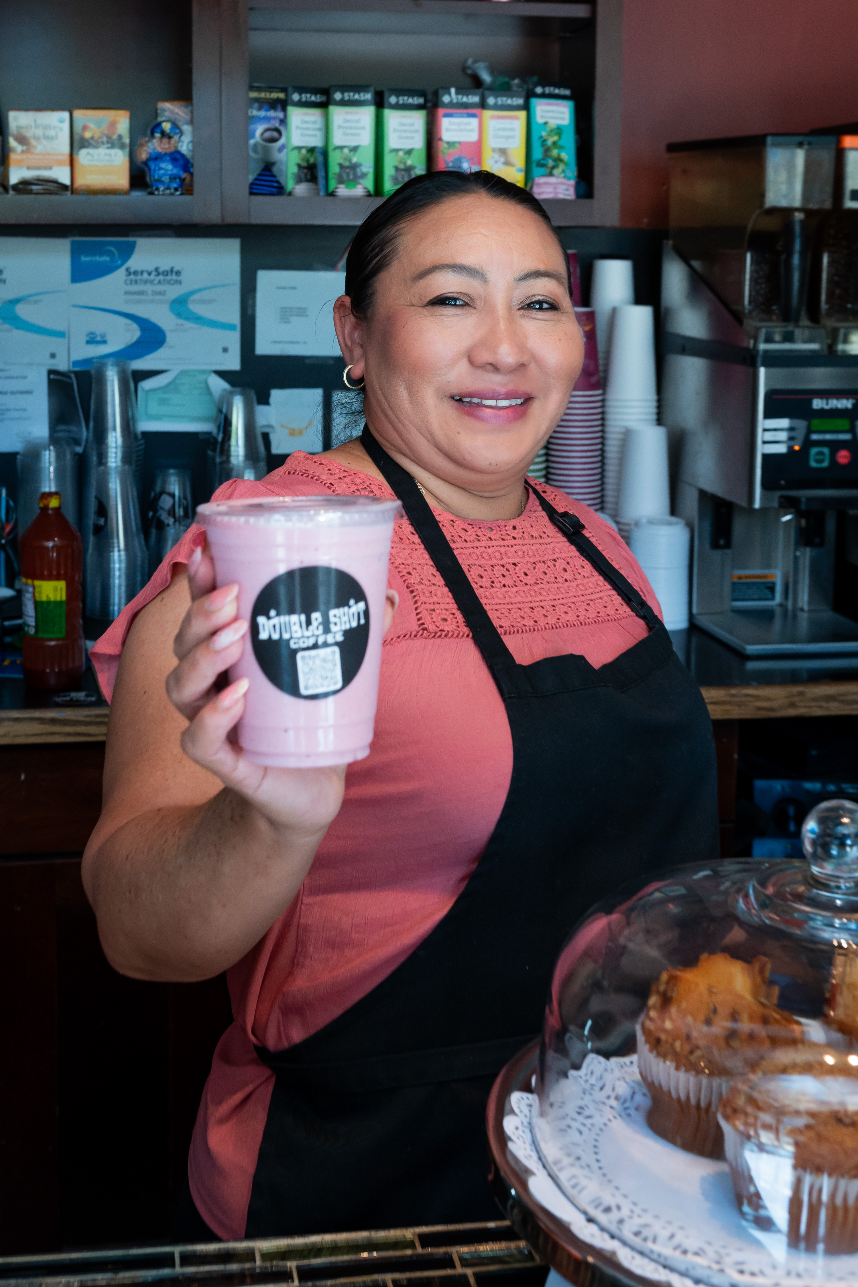 Person holding a pink drink