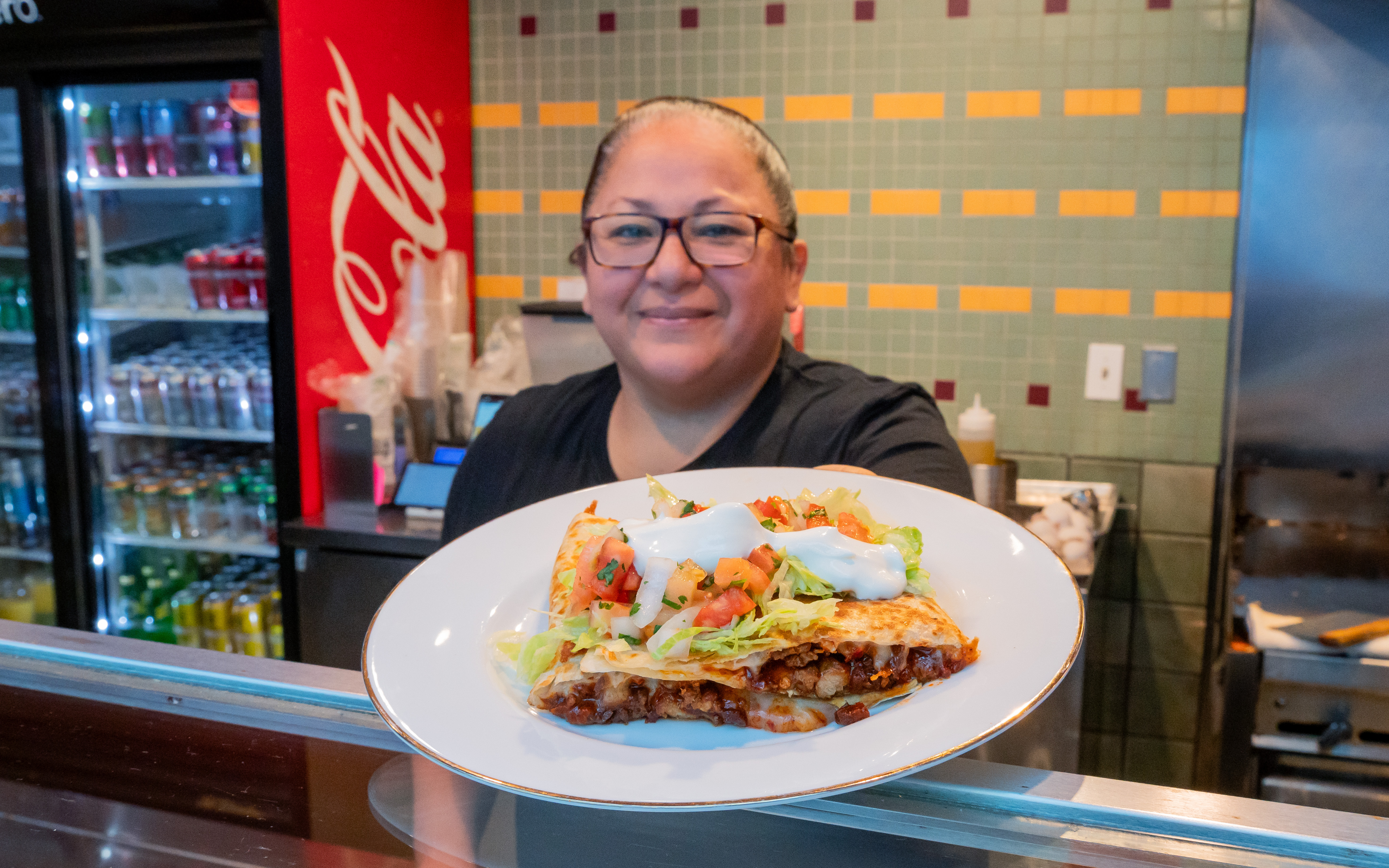 Karim holding out a plate