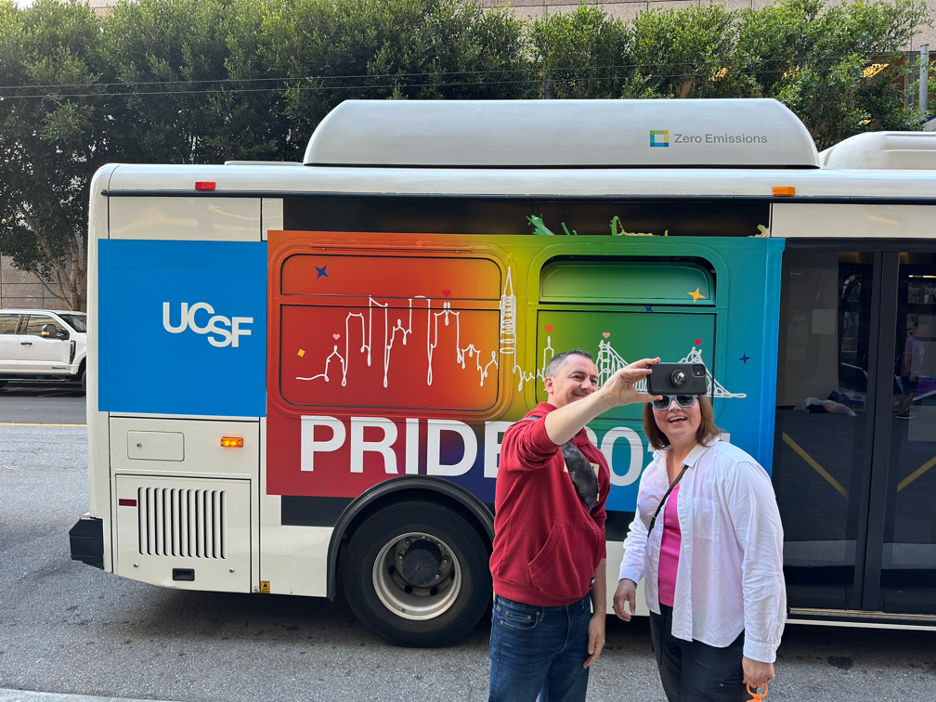 two people take a selfie outside the PRIDE shuttle