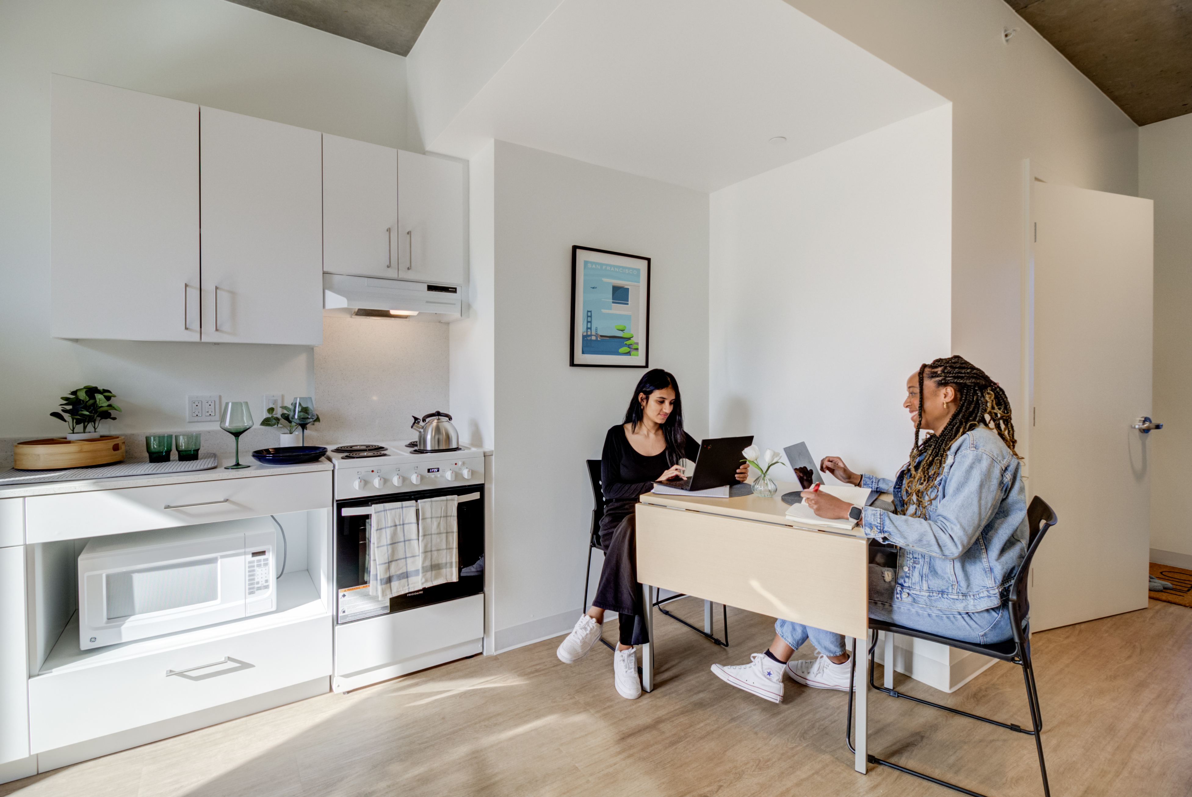 Students sitting at a dest inside an Academe 198 apartment