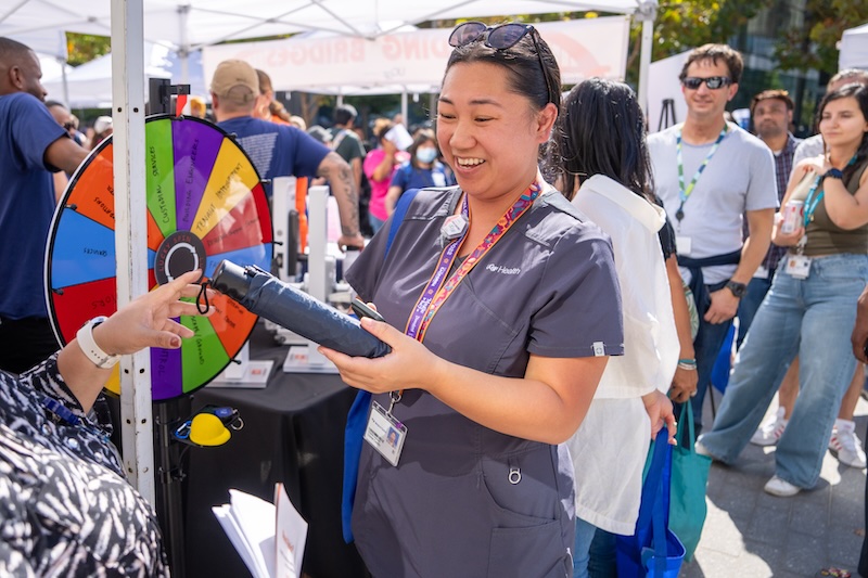 Someone hands an umbrella to a woman