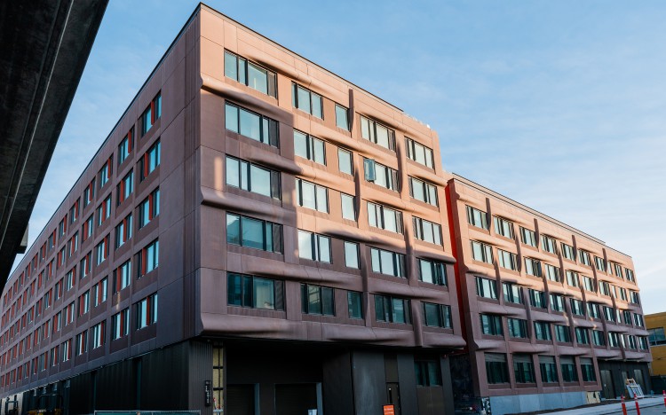Corner of six-story building with brown facade