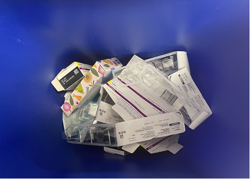 Recycling bin with paper and thin plastic.