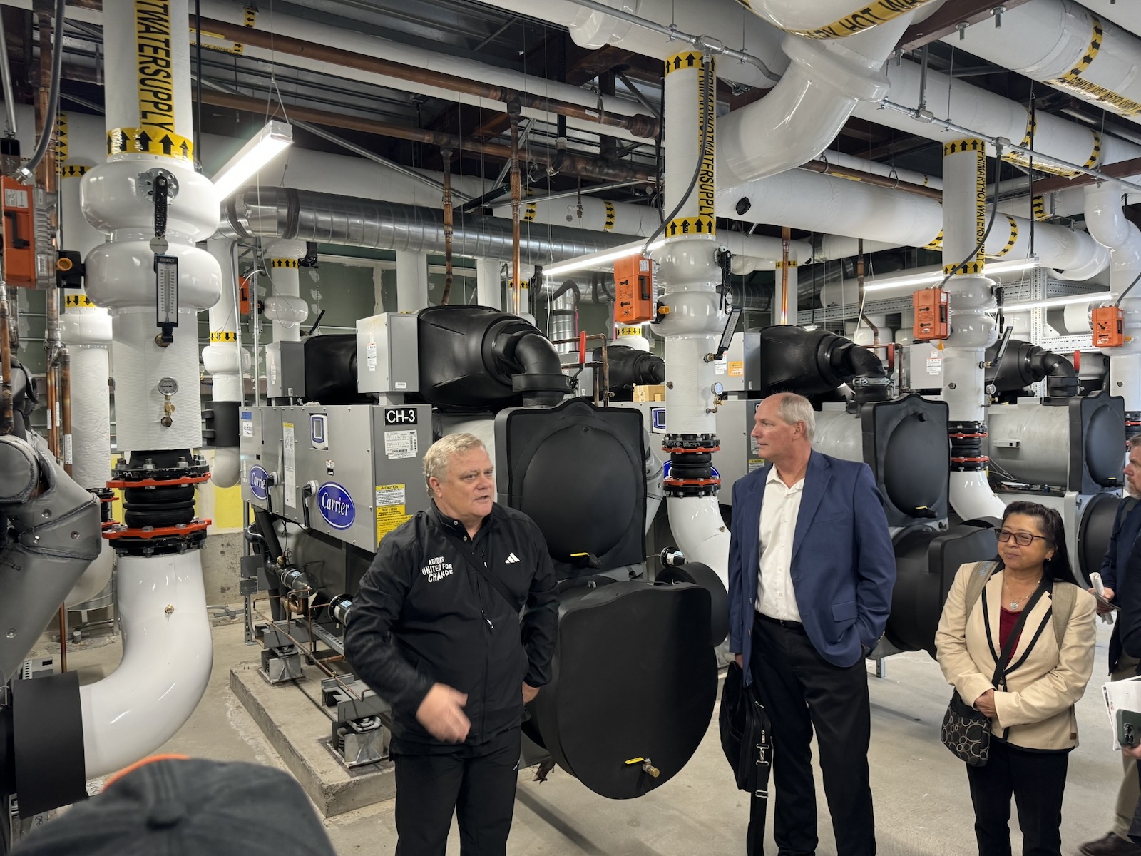 Design Engineer Jeff Blaevoet tells the tour group about the heat recovery system that is installed in the Bayfront Medical Center. 