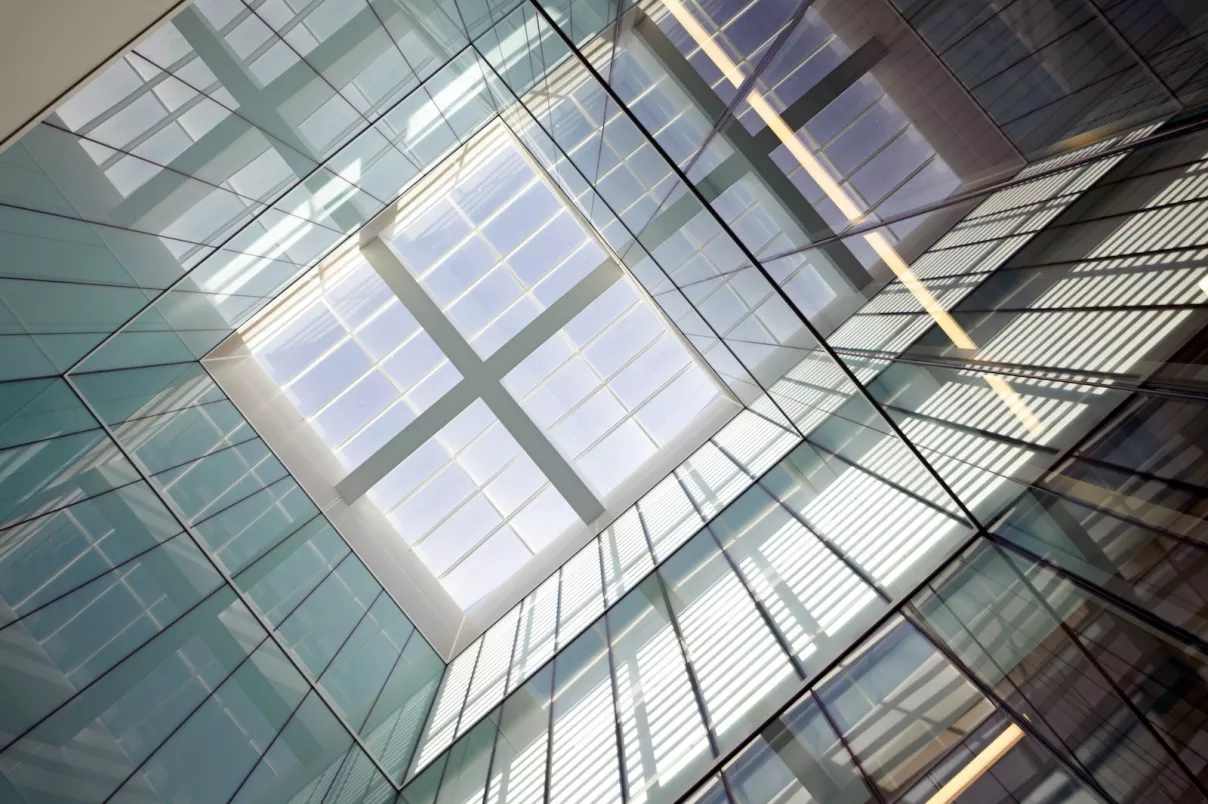 The image shows the stunning, light-filled interior glass atrium and central skylight of the CVRI building